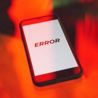 Mobile phone with the word error on it, surrounding by a red and orange fluid background